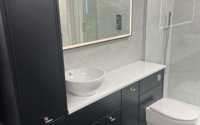 Fitted storage basin toilet - sleek black cabinetry with modern design elements