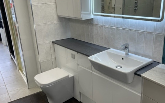 Fitted vanity with LED mirror showcasing modern bathroom design.